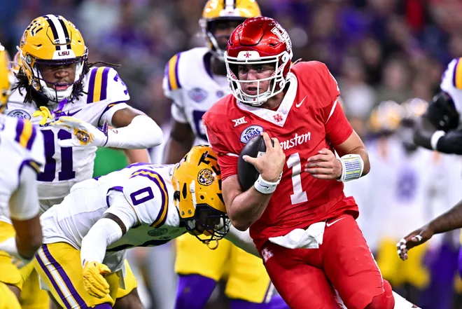 Dec 27, 2025; Houston, TX, USA; Houston Cougars quarterback Conner Weigman (1) runs the ball during the first half against the Louisiana State Tigers at NRG Stadium. Mandatory Credit: Maria Lysaker-Imagn Images