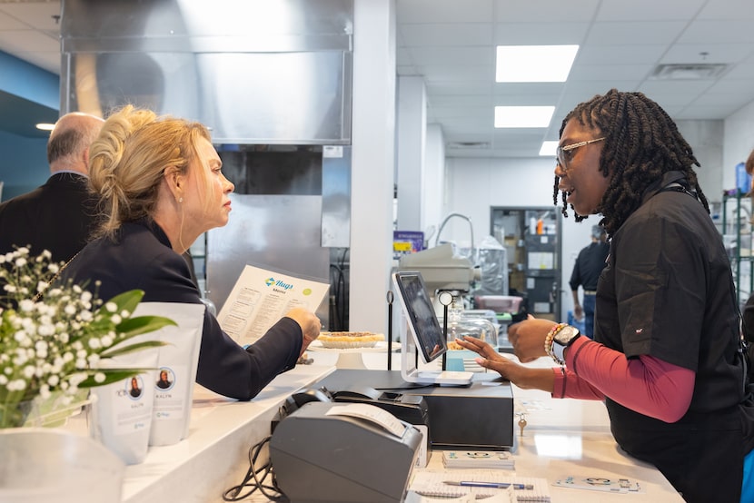 Simone, a Hugs Cafe employee, takes an order at the new Dallas restaurant.
