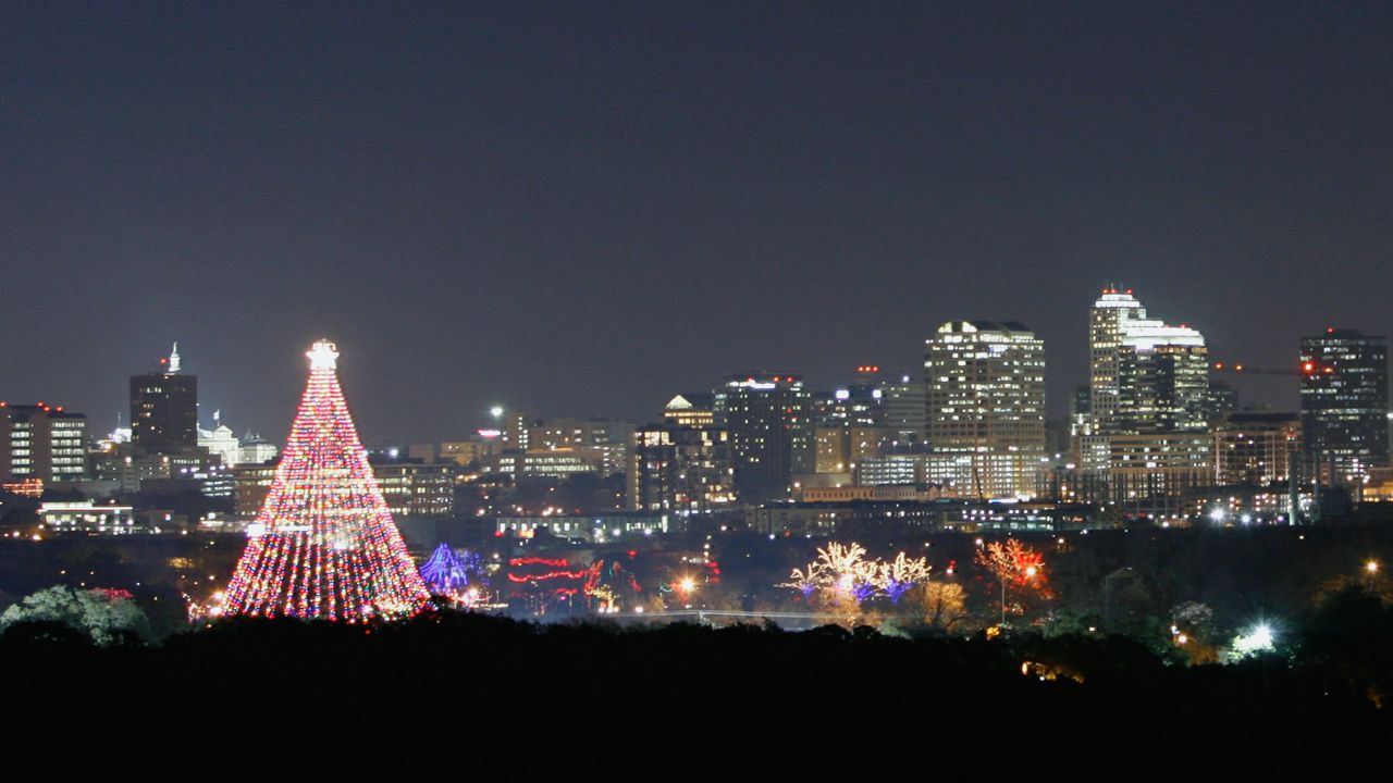 A huge holiday tree of lights in Ziilker Park is seen in the foreground, with the skyline's lights in the background, Thursday, Dec. 14, 2006, in Austin, Texas. (AP Photo/Harry Cabluck)