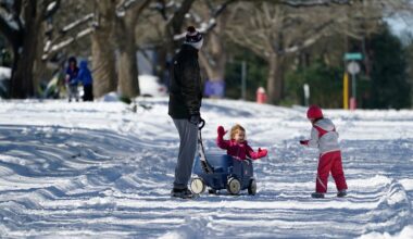 Craig Crow, left, walk through the snow with his daughters, Elizabeth, center, and Olivia, right, Monday, Feb. 15, 2021, in San Antonio. San Antonio received 3-5 inches of snow over night. (AP Photo/Eric Gay)