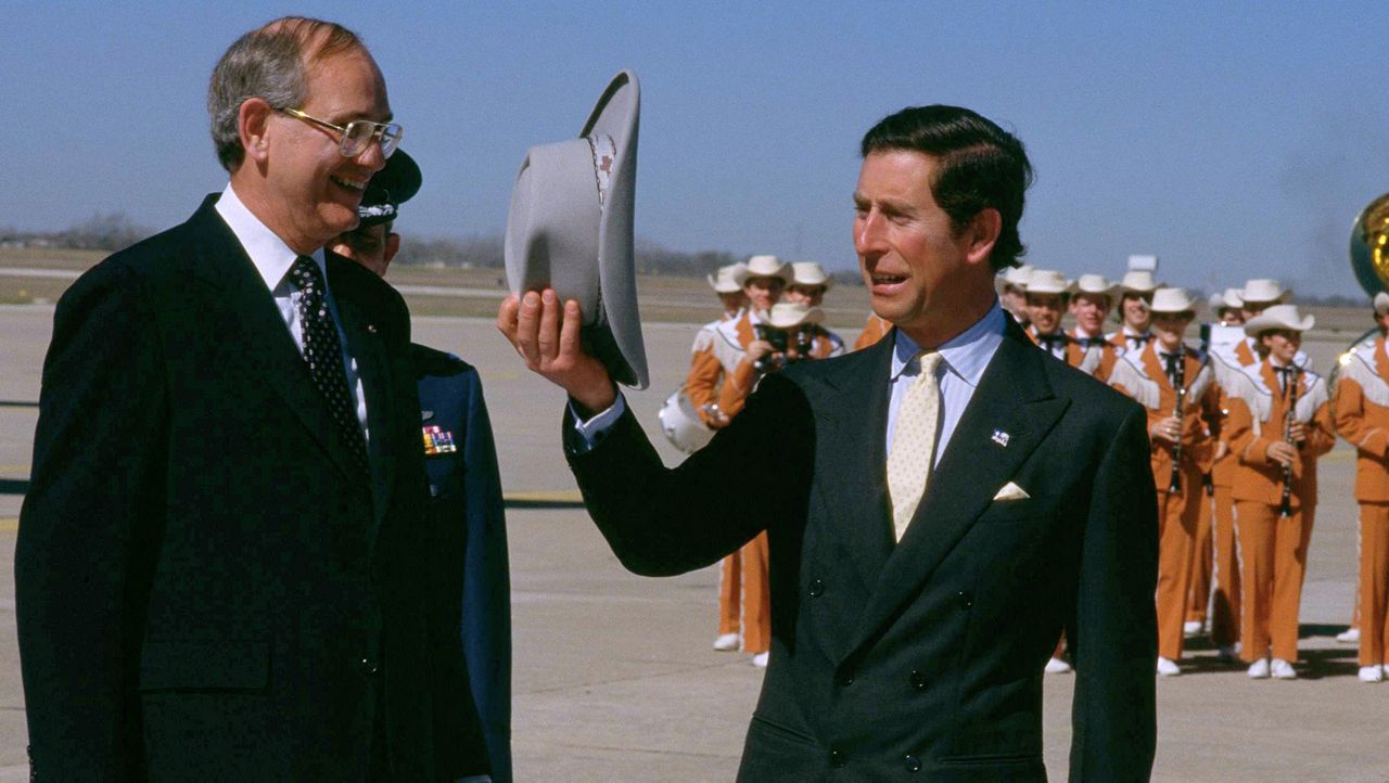 Prince Charles trying on a cowboy hat is shown with Mayor Frank Cooksey in Austin, TX on Thursday, Feb. 20, 1986. (AP Photo/John Keating)