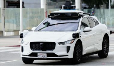 A passenger inside a Waymo vehicle looks out of the window while leaving the San Jose Mineta International Airport, Wednesday, Nov. 12, 2025, in San Jose, Calif. (AP Photo/Godofredo A. Vásquez)