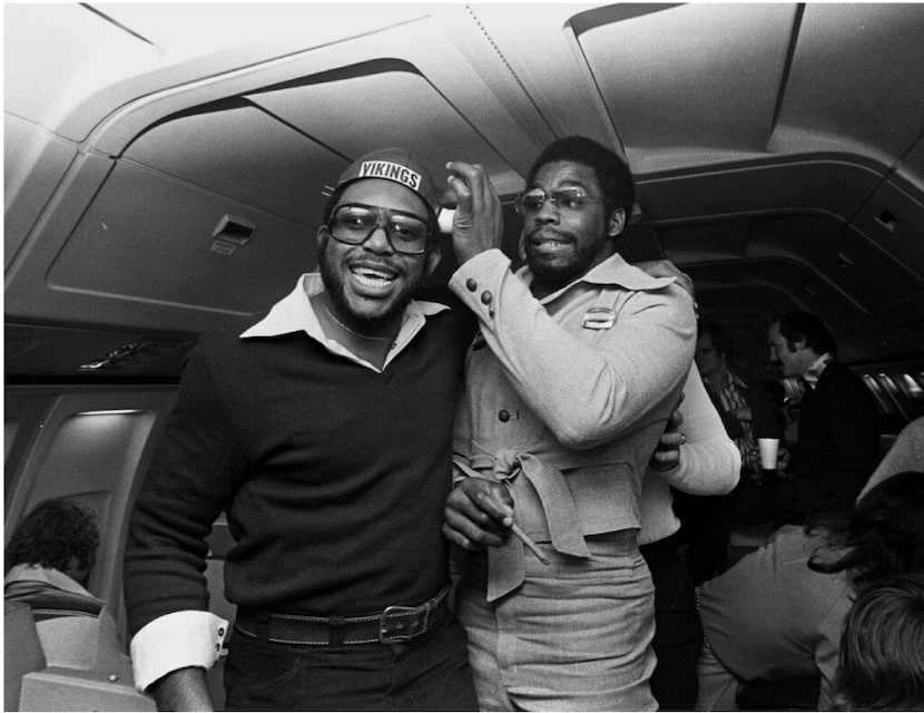 Harvey Martin, left, and Ed “Too Tall” Jones happily ham it up with a one-horned Vikings...