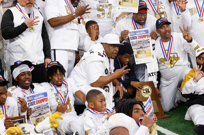 South Oak Cliff head coach Jason Todd (center) poses for a photo with the trophy after a...