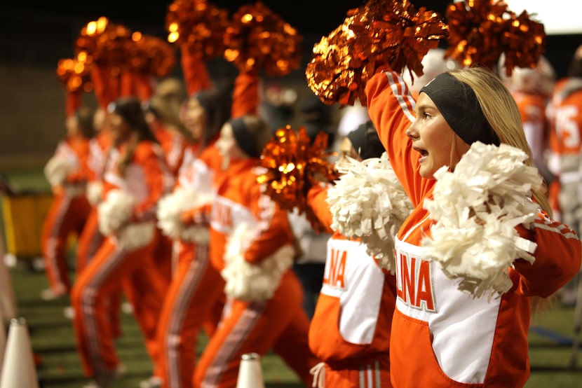 The varsity cheerleaders hype up the crowd during a Celina High School football game against...