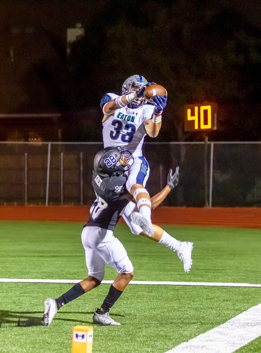 Eaton's Ben Roberts catches a ball during a high school football game against Hebron....