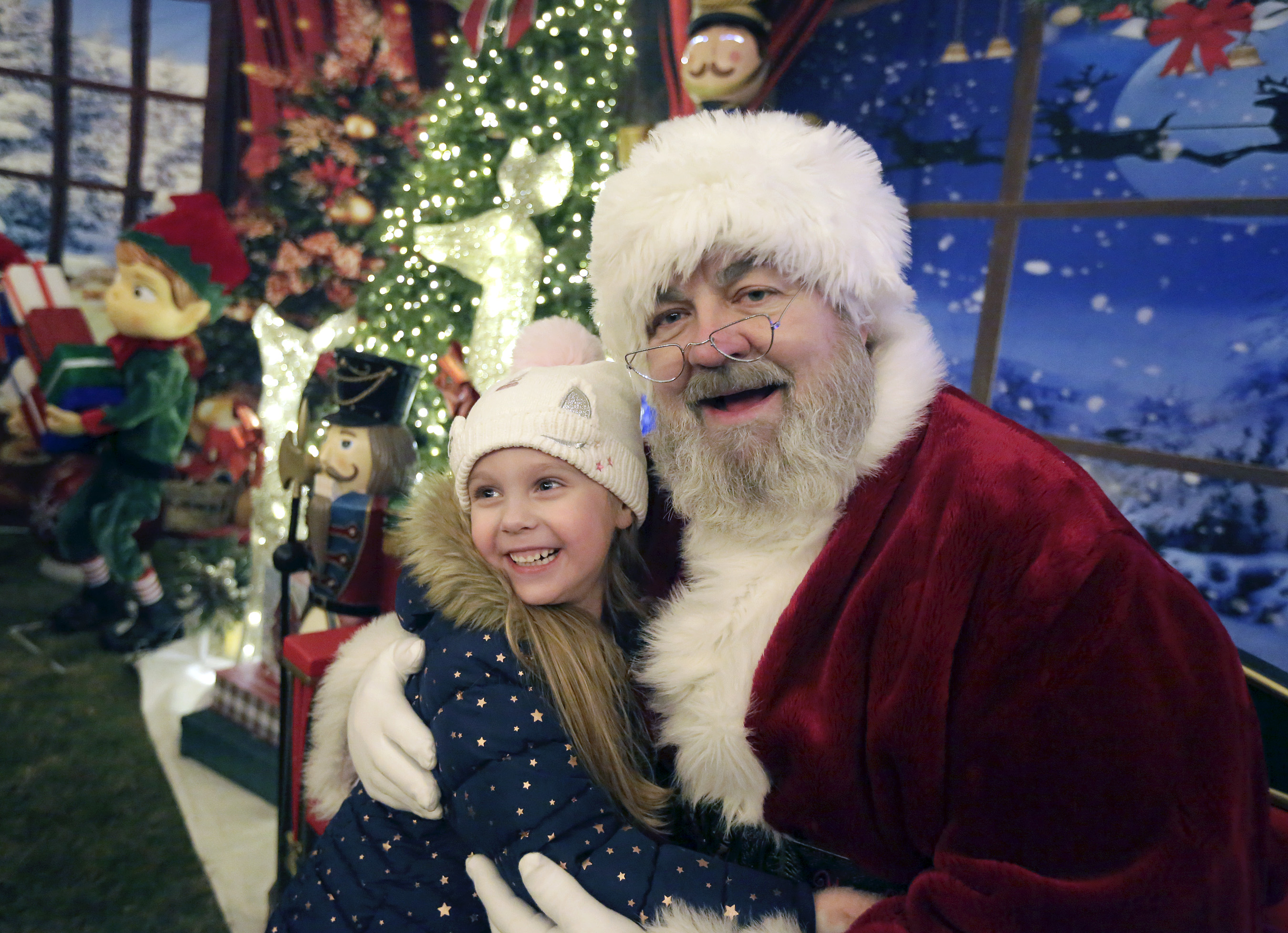 Five-year-old Keira Hubbard, of Shavertown, hugs Santa during the 9th...