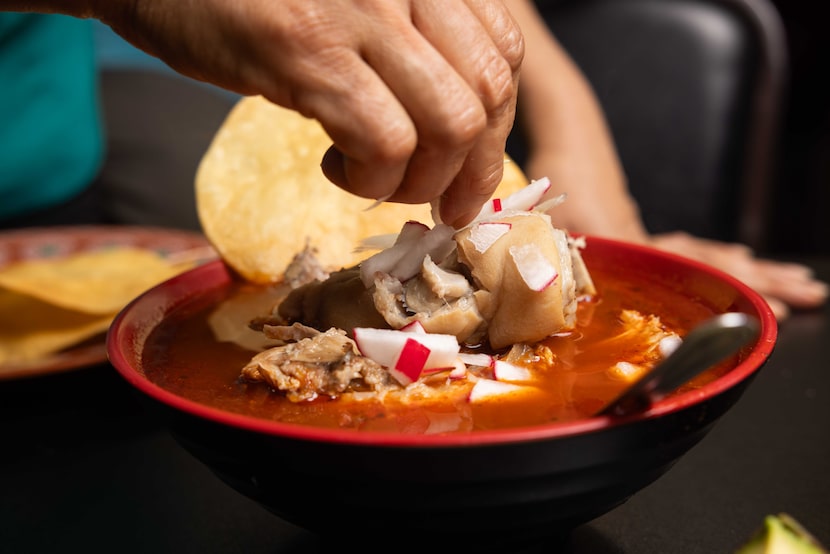 Radish is added to the pozole rojo at La Cocina del Bony Boy in Dallas on Thursday, Aug. 14,...