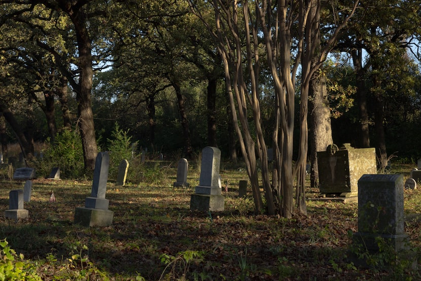 Tombstones are illuminated in the morning light near the Oakland Prairie Project Nov. 25, 2025.