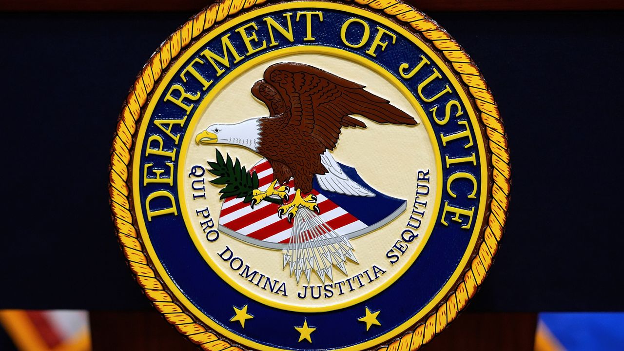 The U.S. Department of Justice logo is seen on a podium before a press conference, May 6, 2025, at the Justice Department in Washington. (AP Photo/Julia Demaree Nikhinson)