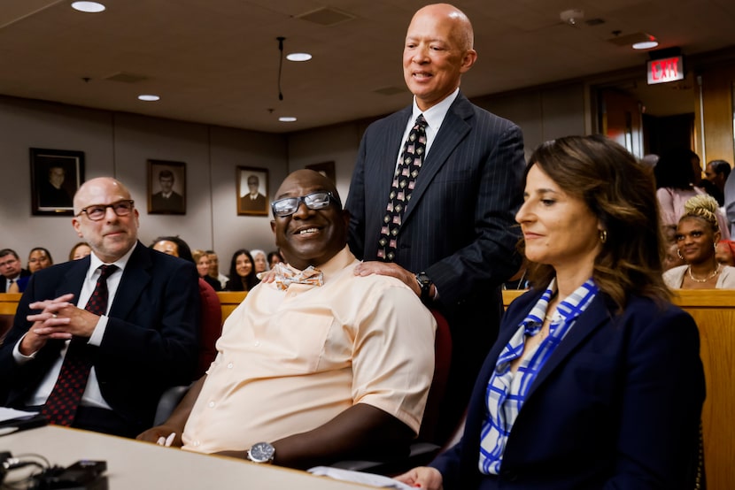 Dallas County District Attorney John Creuzot puts his hands on Tyrone Day’s shoulder after...