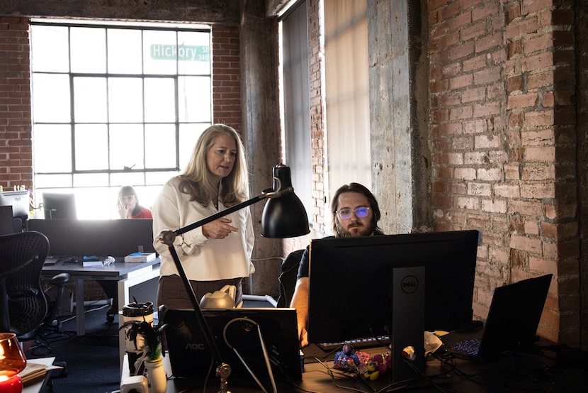 Nancy Hairston, MedCAD president and CEO, speaks with Preston White, a biomedical designer,...