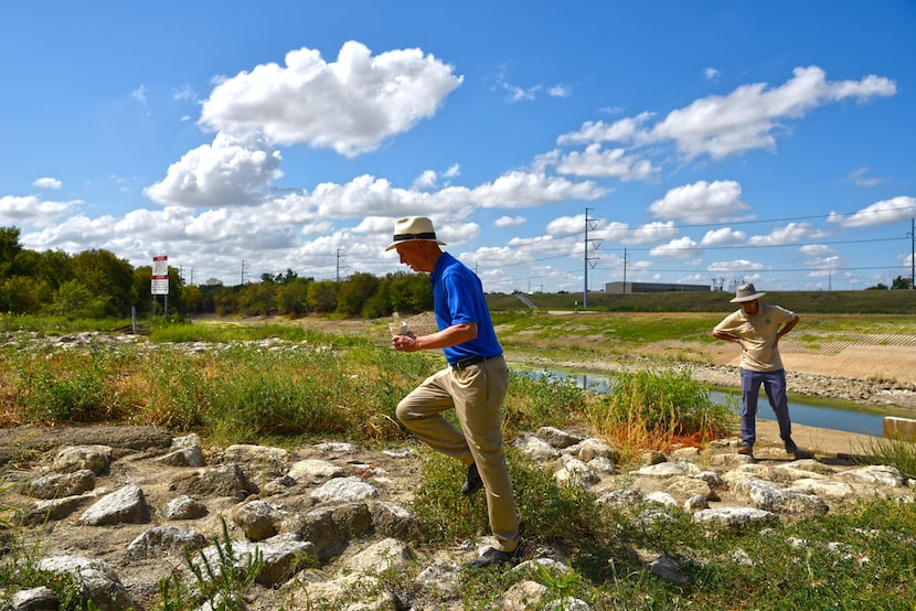 Garrett Boone carries litter he calls a "Trinity River cocktail" collected during his walk...