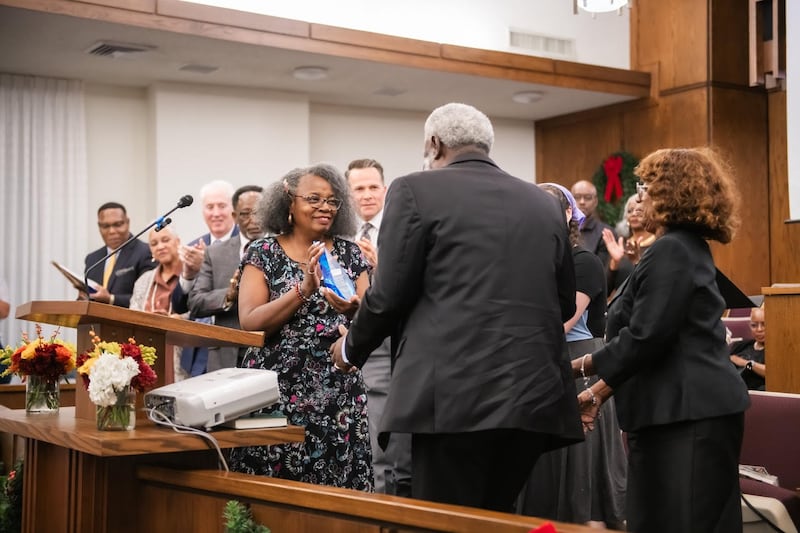 Sabra Stewart-Johnson presents Vernon and Linda James with a service award for all their work with Fort Worth Save Our Children Learning Center at the Saints in Unity devotional in Fort Worth, Texas, on Nov. 16, 2025.