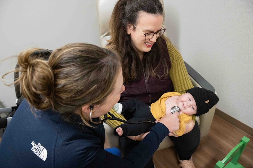 Mother Martha Penturf holds her 4-month-old son Atlas, who had open heart surgery in...