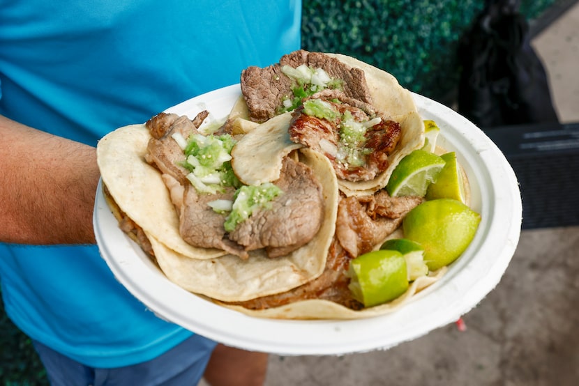 Dallasite Drew Stephenson shows off his taco plate at the El Califa de León taquería pop-up...