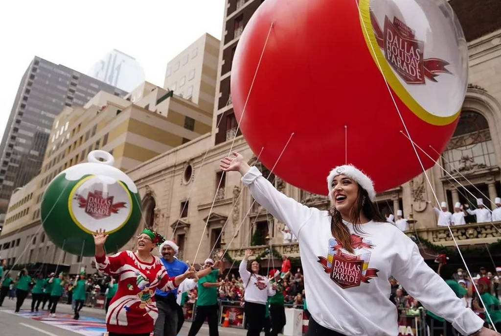 Image shows people in festive spirits during the Dallas Holiday Parade.