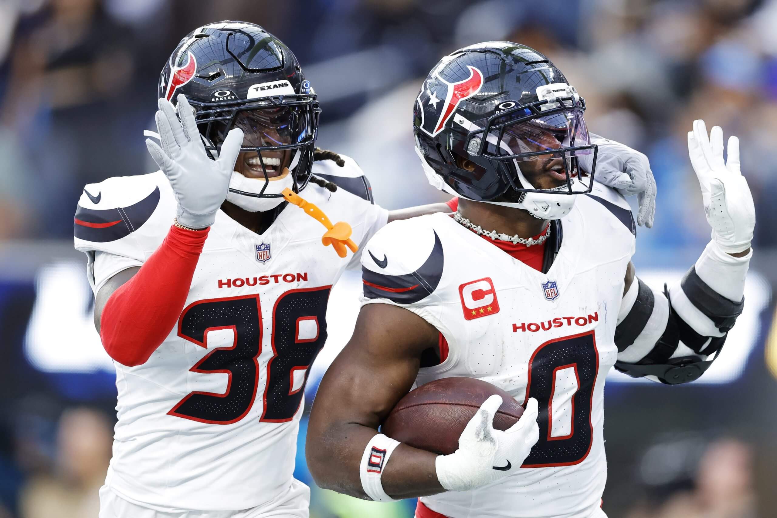 Azeez Al-Shaair and K'Von Wallace of the Houston Texans celebrate Al-Shaair's interception against the Los Angeles Chargers
