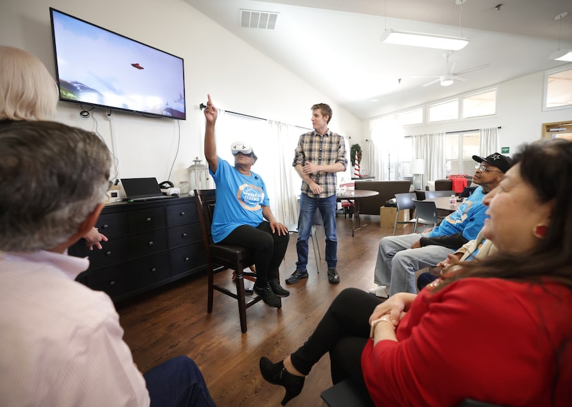 Theresa Steward, center, experiences virtual skydiving as Mynd Immersive and Lyda Hill...