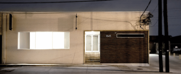 A night image of a one-story gallery building.
