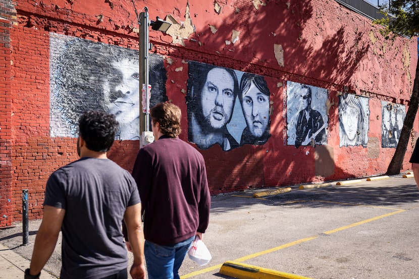 People walk past Frank Campagna's mural in Deep Ellum on Thursday, Nov. 13, 2025, in Dallas....