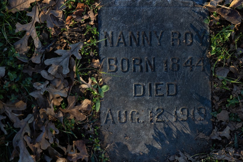 The grave marker for Nanny Roy, who worked for the Samuell family, is surrounded by fall...