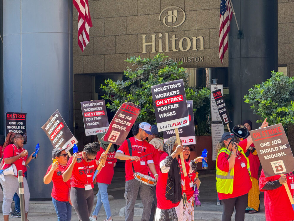 Workers picket outside of the Hilton Americas-Houston to demand higher wages. Sept. 2, 2025.