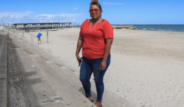 Love Sanchez, founder of Indigenous People of the Coastal Bend, stands at McGee Beach near downtown Corpus Christi in 2022. Credit: Dylan Baddour/Inside Climate News