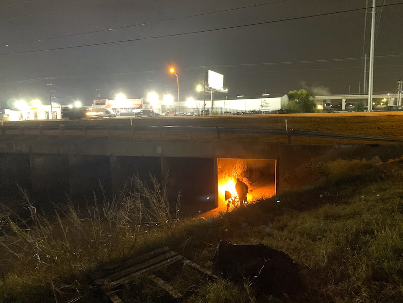 Late Friday night, a woman living beneath Harry Hines Boulevard lit a fire beneath Tunnel...