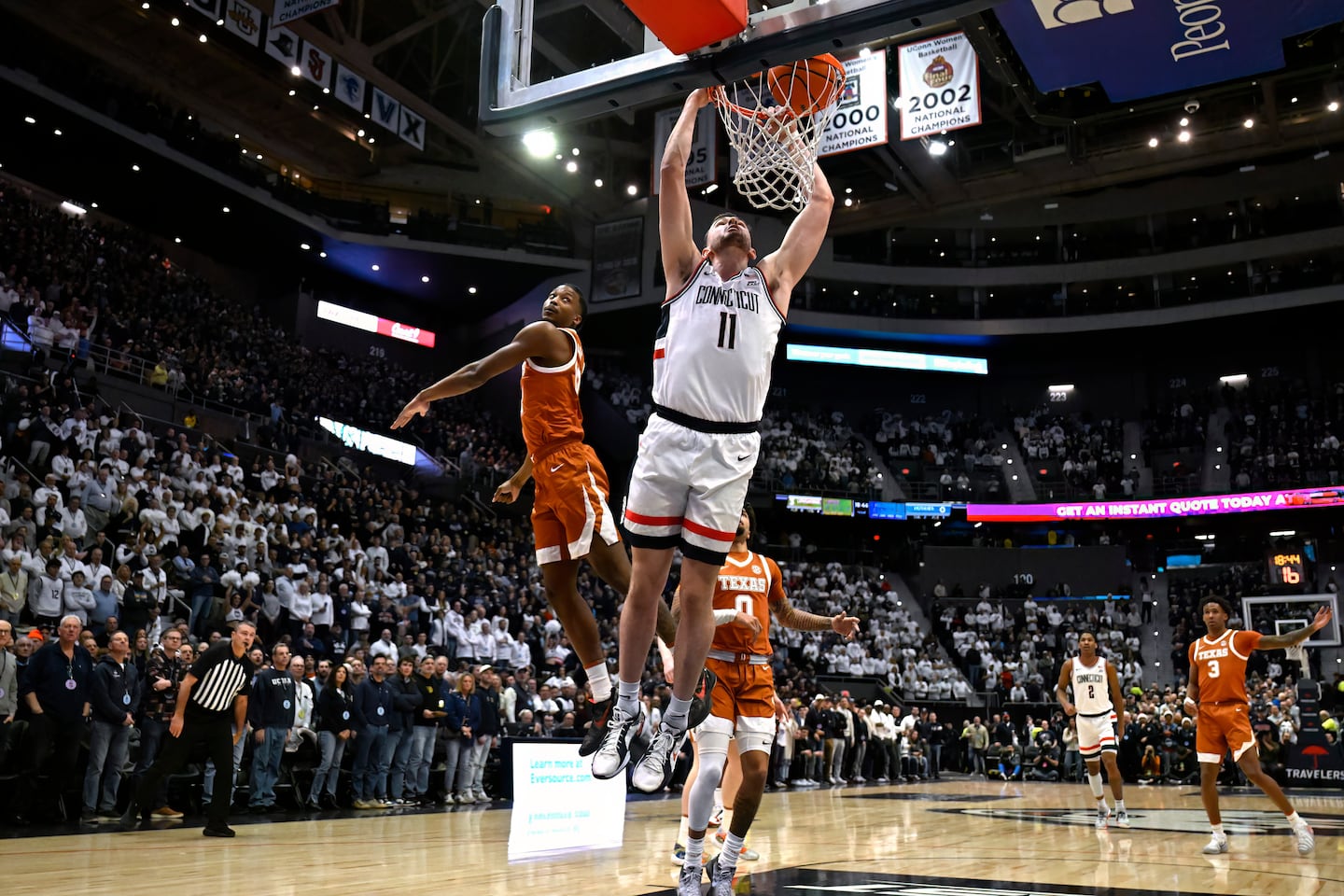 UConn forward Alex Karaban (11) dunks in the first half of a game against Texas Friday night.