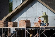 Construction is seen on homes in the Monticello Park subdivision on Monday, Sept. 8, 2025,...