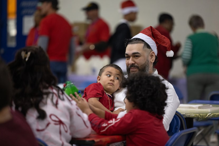 Adrian Casares, an inmate at the Sanders Estes Unit prison in Venus, plays with his sons...