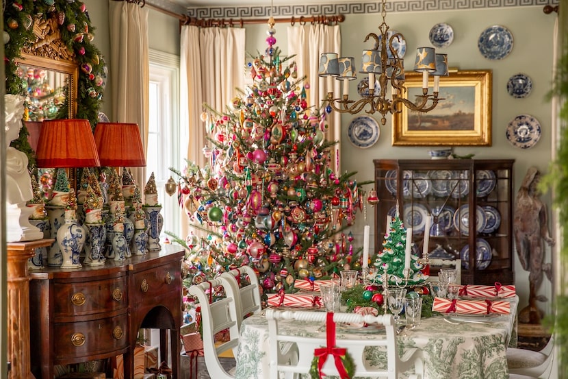 Dining room with vintage table, large Christmas tree, buffet sideboard with Delft pottery