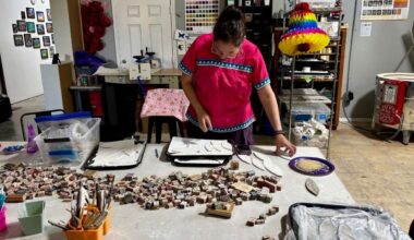 Wanda Montemayor sorts tiles for the Kerr County Love Project's mosaic mural. (Spectrum News 1/Hannah Maguire)