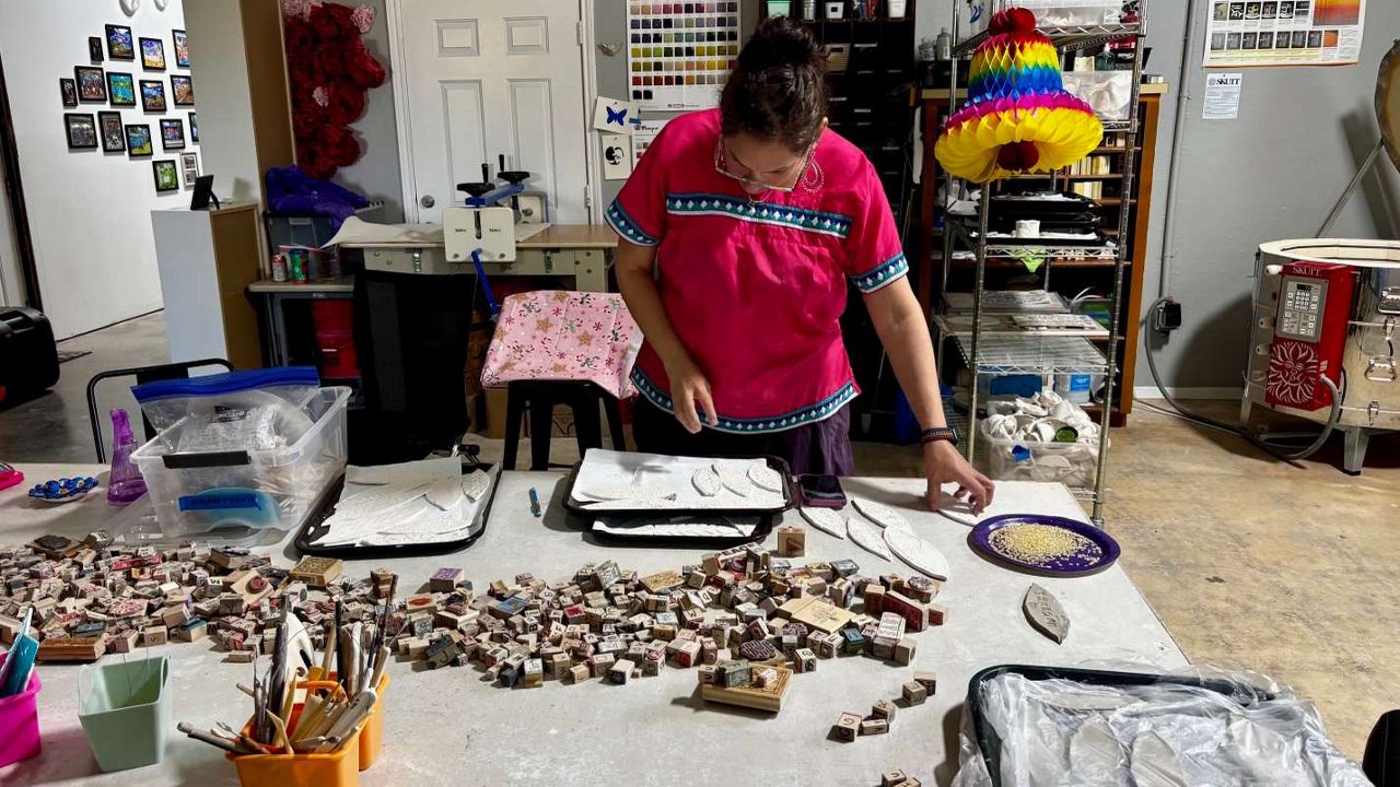 Wanda Montemayor sorts tiles for the Kerr County Love Project's mosaic mural. (Spectrum News 1/Hannah Maguire)