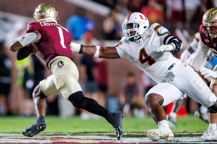 Miami defensive lineman Rueben Bain Jr. (4) tries to grab Florida State quarterback Tommy...