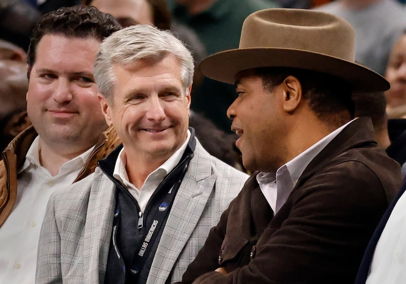 Dallas Mavericks CEO Rick Welts (left) visits with Dallas Mayor Eric Johnson during a second...