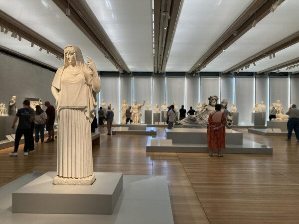 An installation image of a gallery showcasing marble statues.
