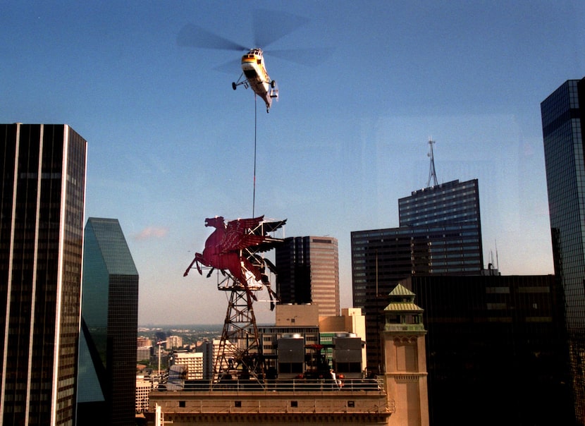 In 1999, workers used a helicopter to lower a crane next to Dallas' historic icon, Pegasus,...