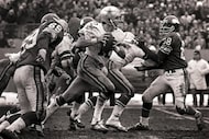 Cowboys quarterback Roger Staubach (12) scrambles for yardage during the final minutes of...