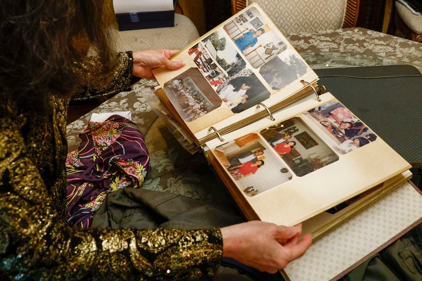 Jennifer Nguyen looks through a family photo album at her home, Monday, Nov. 24, 2025, in...