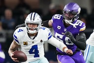 Dallas Cowboys quarterback Dak Prescott (4) scrambles away from Minnesota Vikings linebacker...