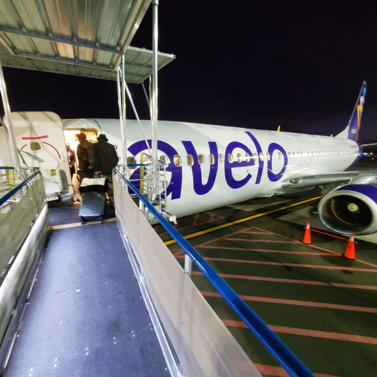 Passengers boarding nighttime Avelo flight