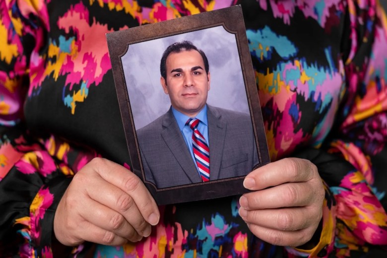 Brandi Rahimi holds a photo of her husband, Shahrokh Rahimi in their home in San Antonio on Dec. 1, 2025.