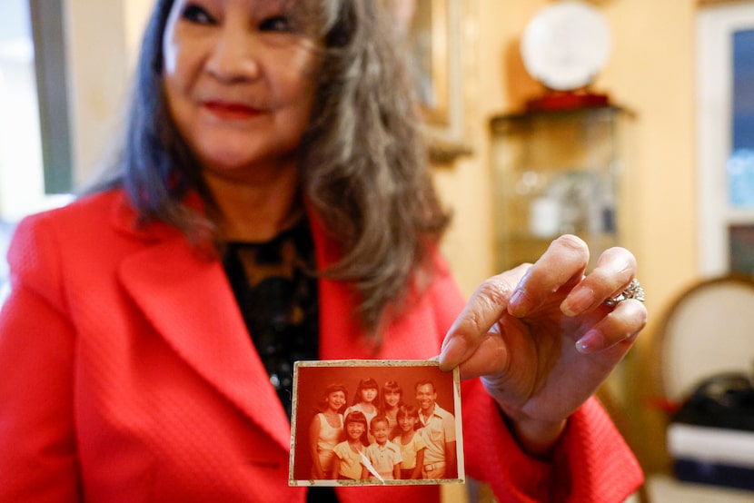 Jennifer Nguyen holds a photo from when her family first arrived in Arizona after fleeing...