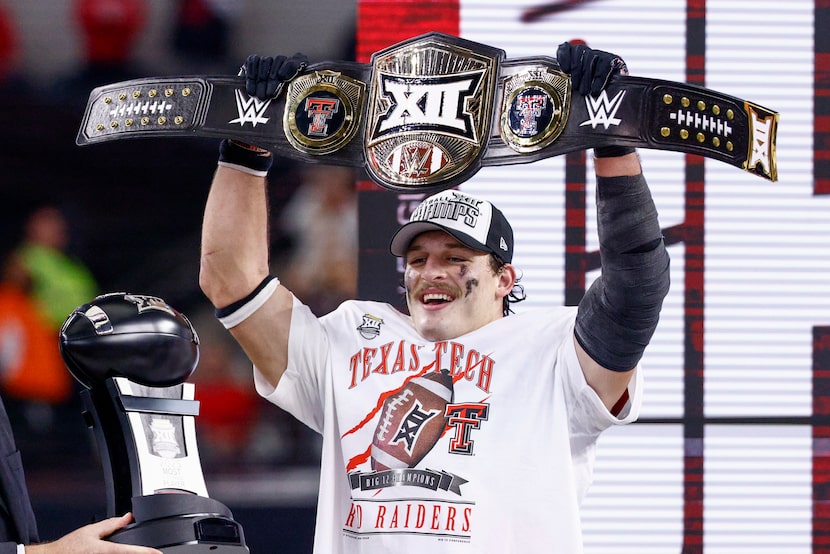 Texas Tech linebacker Ben Roberts hoists the most outstanding WWE player wrestling belt...