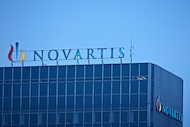 The Novartis logo sits on top of the company's headquarters in Basel, Switzerland, on...