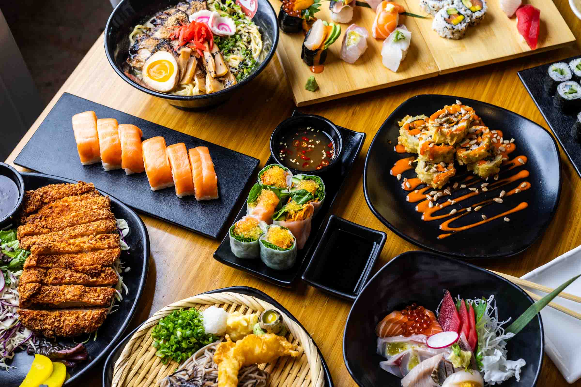 A spread of sushi and fried foods. 