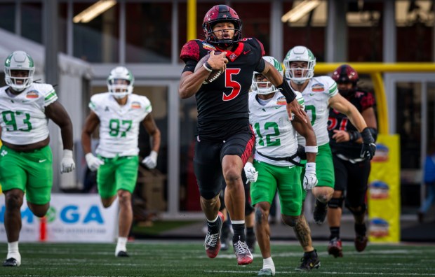 San Diego State quarterback Bert Emanuel Jr., center, runs down the field during the New Mexico Bowl game against North Texas at the University Stadium on Saturday, Dec. 27, 2025. (Jessica Baca / Albuquerque Journal)