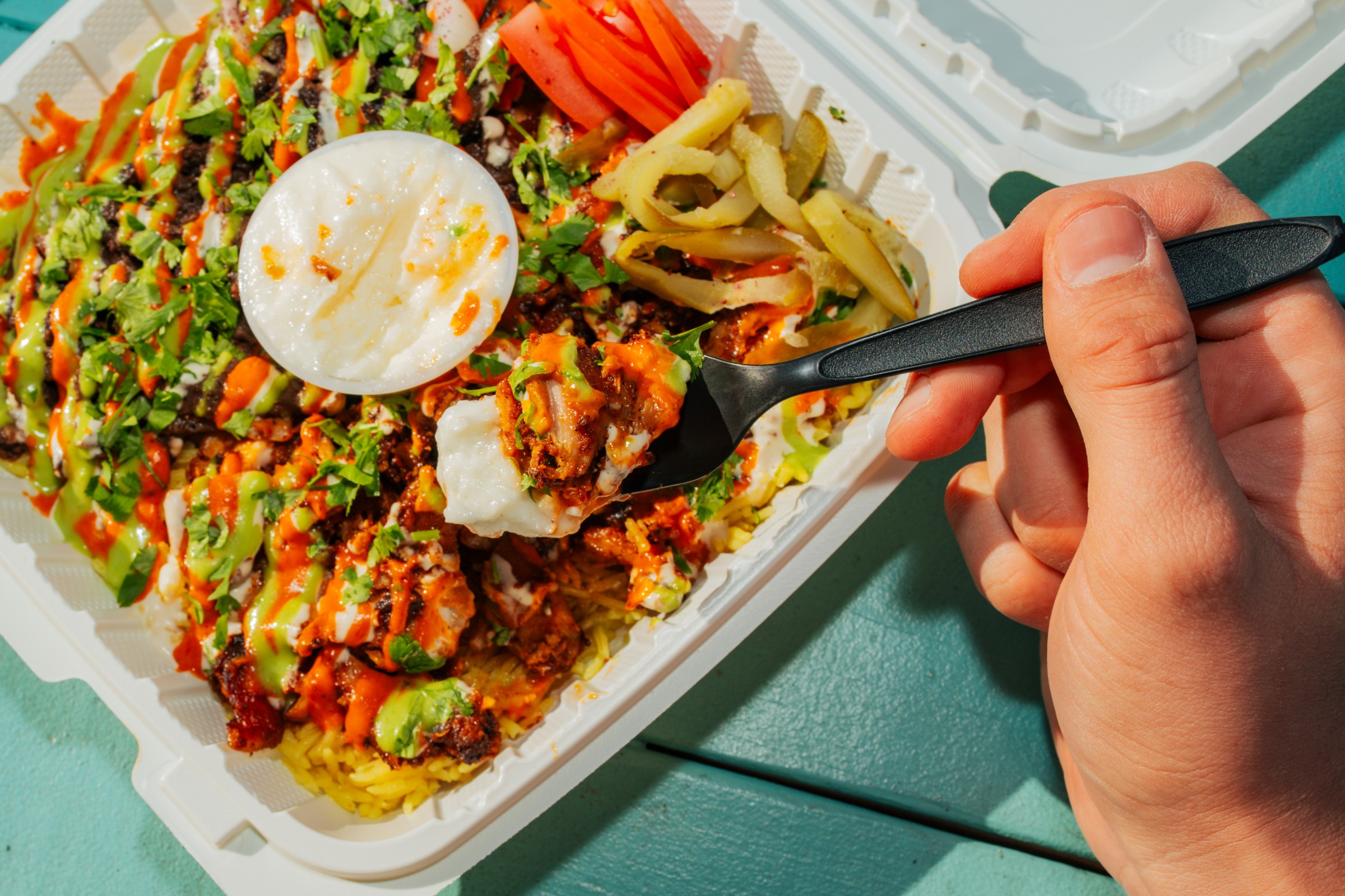 A container of food with meat and veggies.  